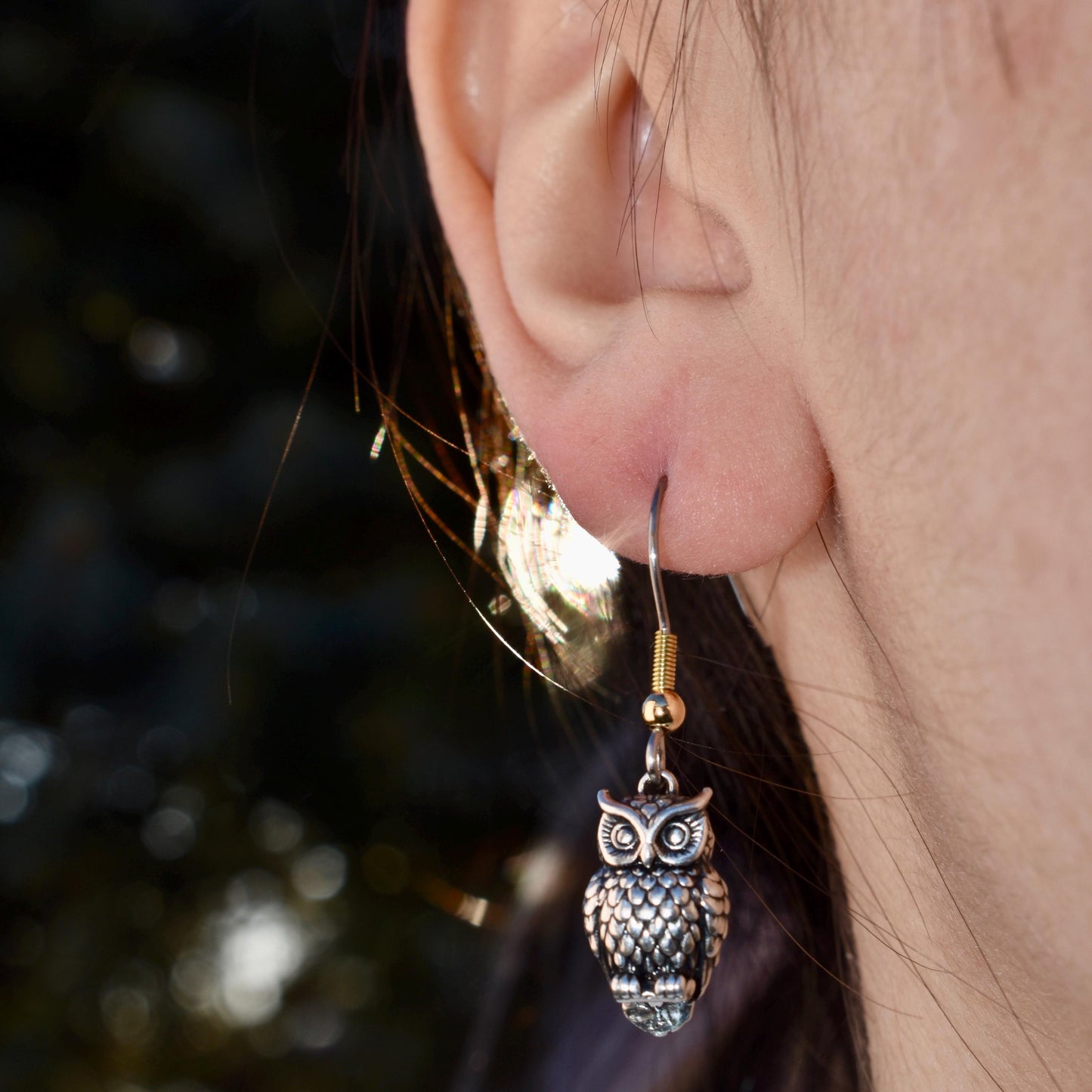 A Woman Wearing A Great Horned Owl Charm As Earrings - Handcrafted .925 Sterling Silver Pendant for Bracelets and earrings by The Colorado Charm Company