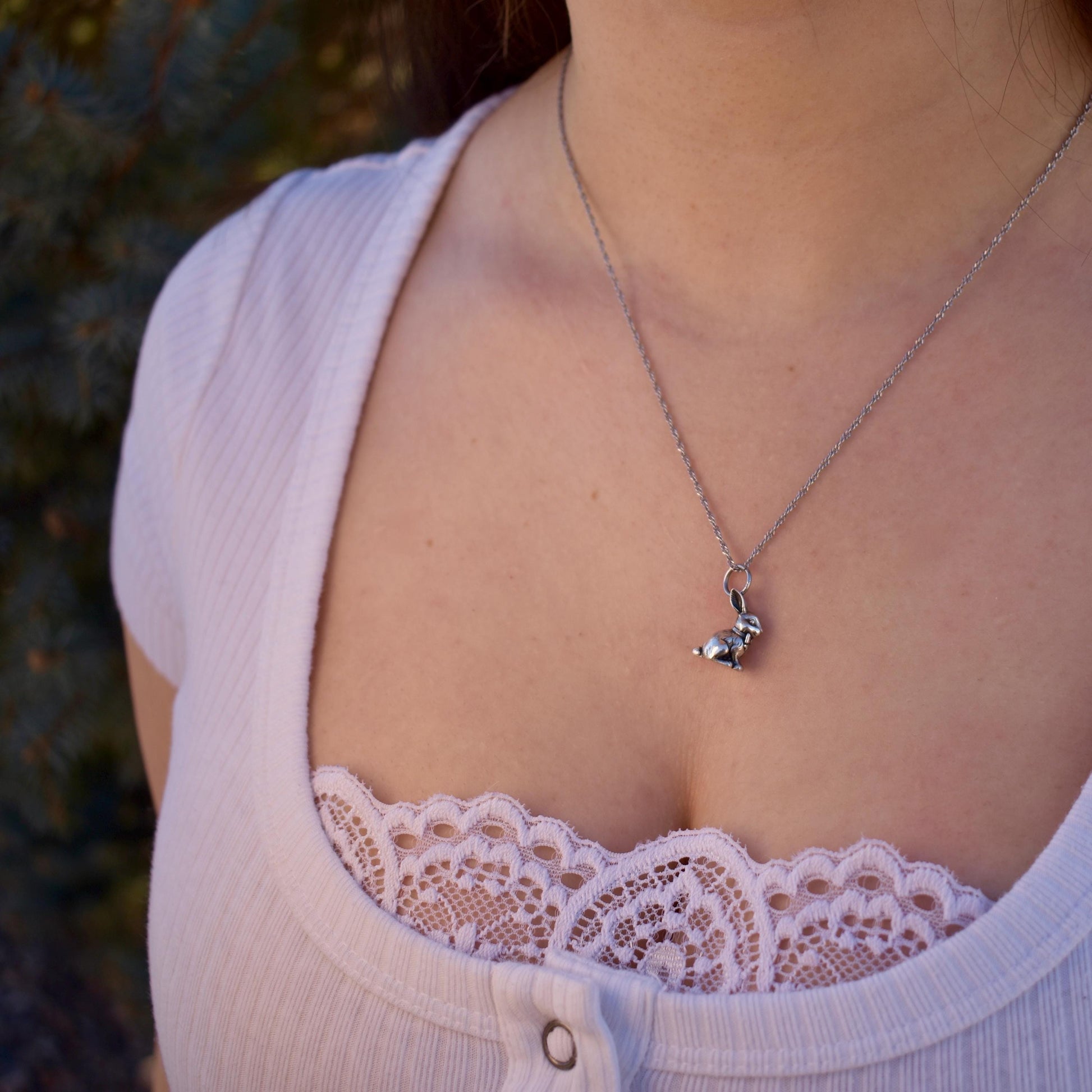 A Woman Wearing a Chocolate Bunny Charm On necklace- Handcrafted .925 Sterling Silver Pendant for Bracelets and earrings by The Colorado Charm Company