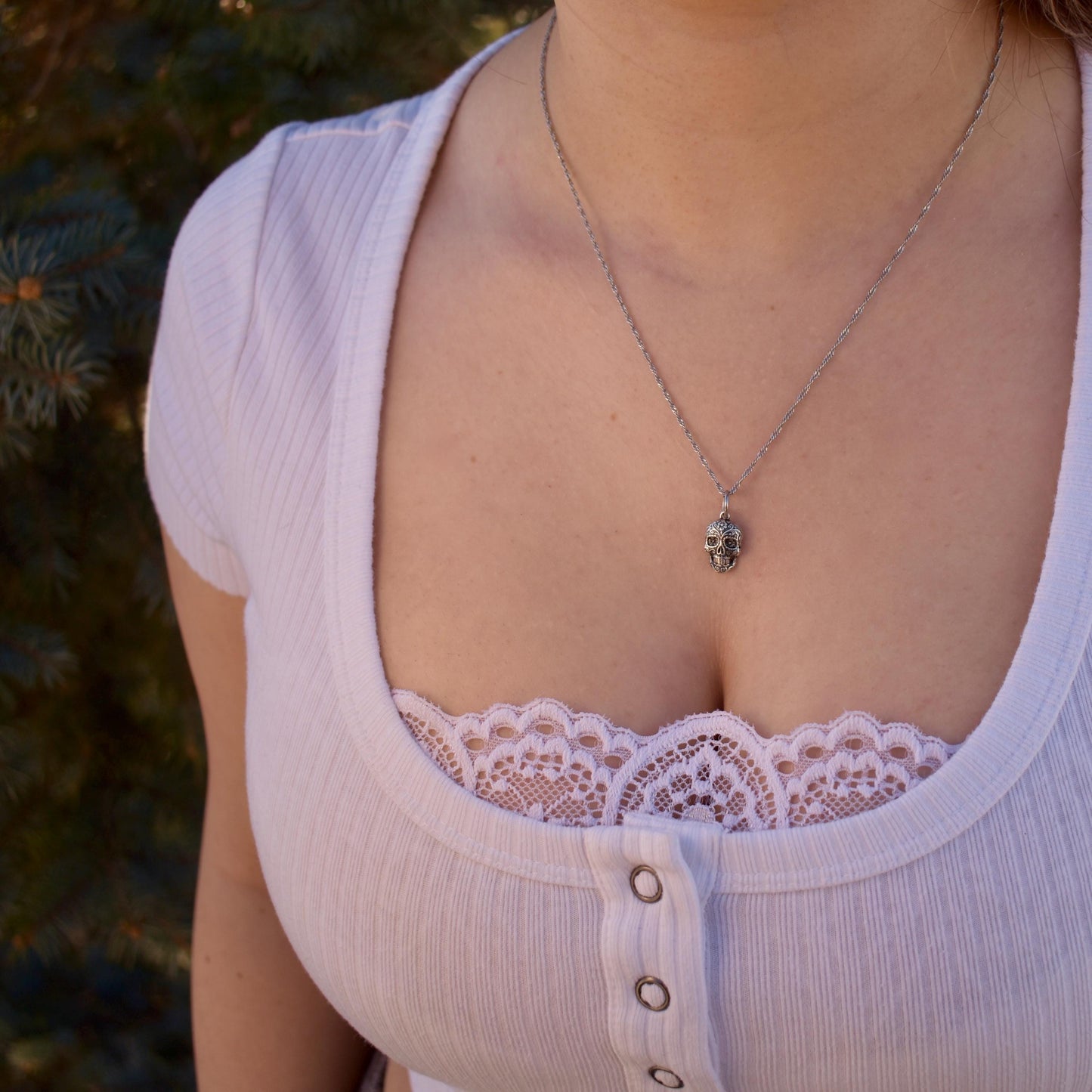 A Woman Wearing A Dia De Los Muertos Sugar Skull Charm On A necklace - Handcrafted .925 Sterling Silver Pendant for Bracelets and earrings by The Colorado Charm Company