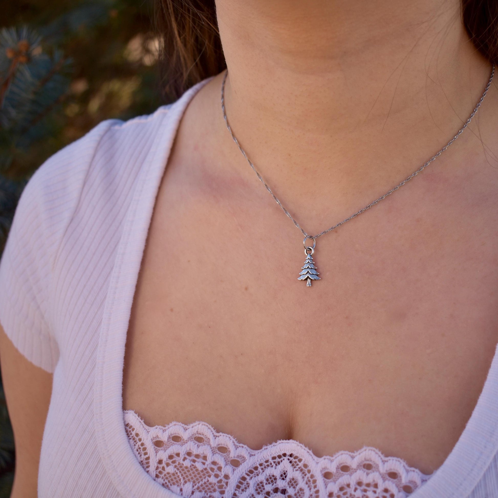 a woman wearing a pine tree charm on a necklace - Handcrafted .925 Sterling Silver Pendant for Bracelets and earrings by The Colorado Charm Company