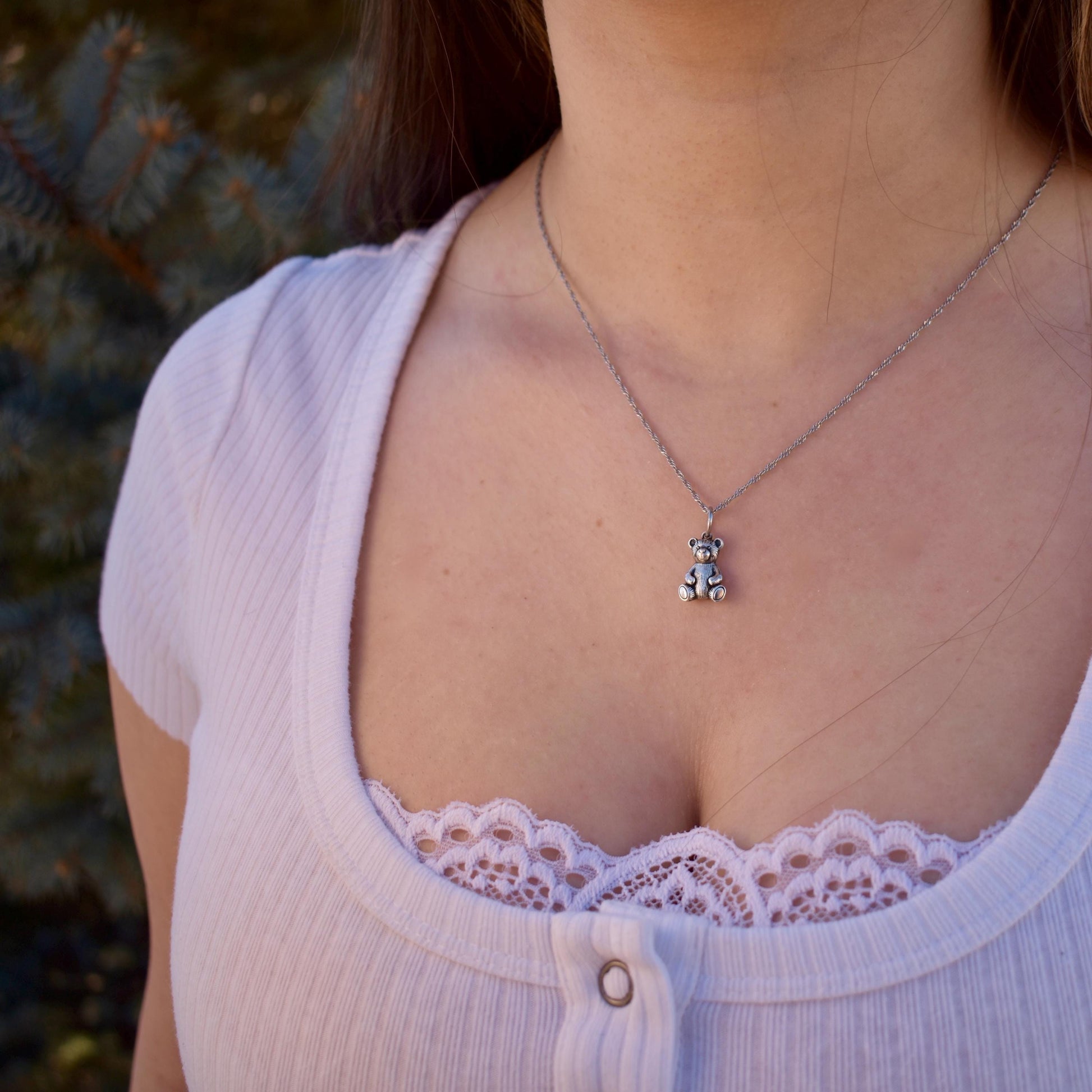A Woman Wearing a Classic Teddy Bear Charm on a Necklace - Handcrafted .925 Sterling Silver Pendant for Bracelets and earrings by The Colorado Charm Company