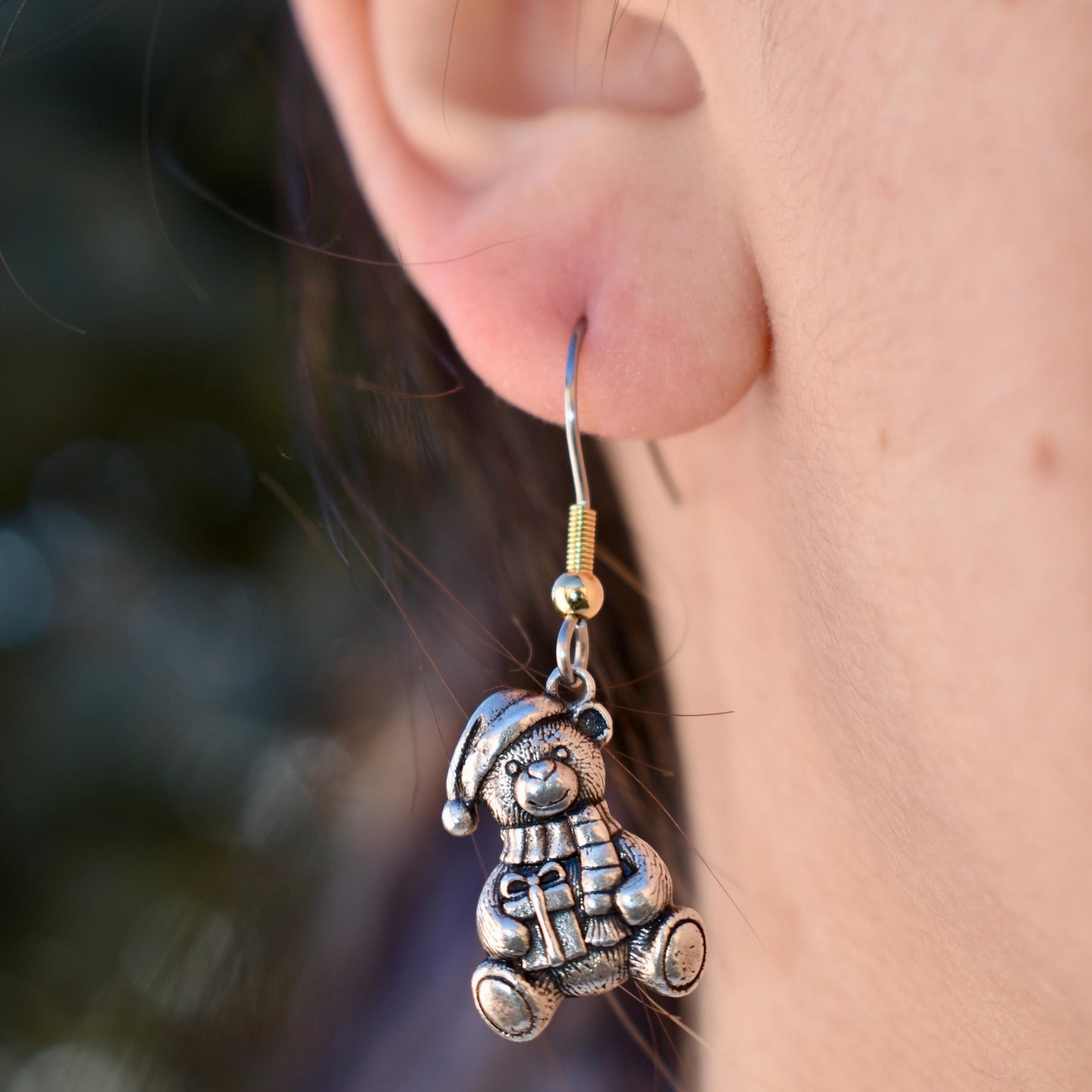 A Woman Wearing A Christmas teddy bear Charm as Earrings - Handcrafted .925 Sterling Silver Pendant for Bracelets and earrings by The Colorado Charm Company