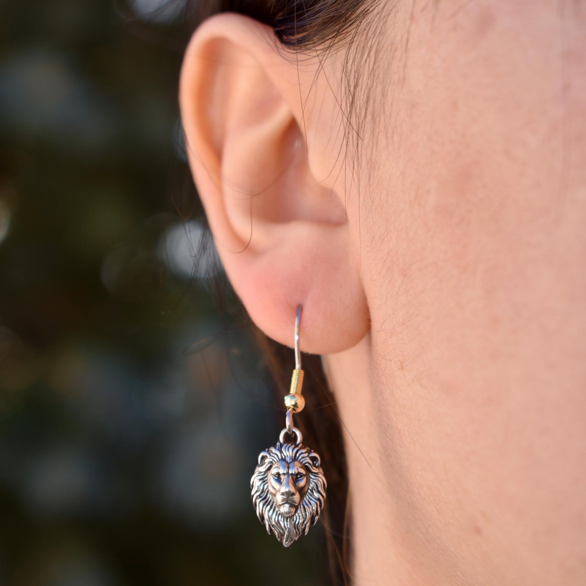 A Woman Wearing A Mighty African Lion Charm earrings - Handcrafted .925 Sterling Silver Pendant for Bracelets and earrings by The Colorado Charm Company