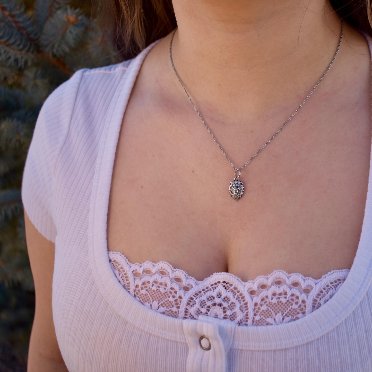 A Woman Wearing A Mighty African Lion Charm On a necklace - Handcrafted .925 Sterling Silver Pendant for Bracelets and earrings by The Colorado Charm Company