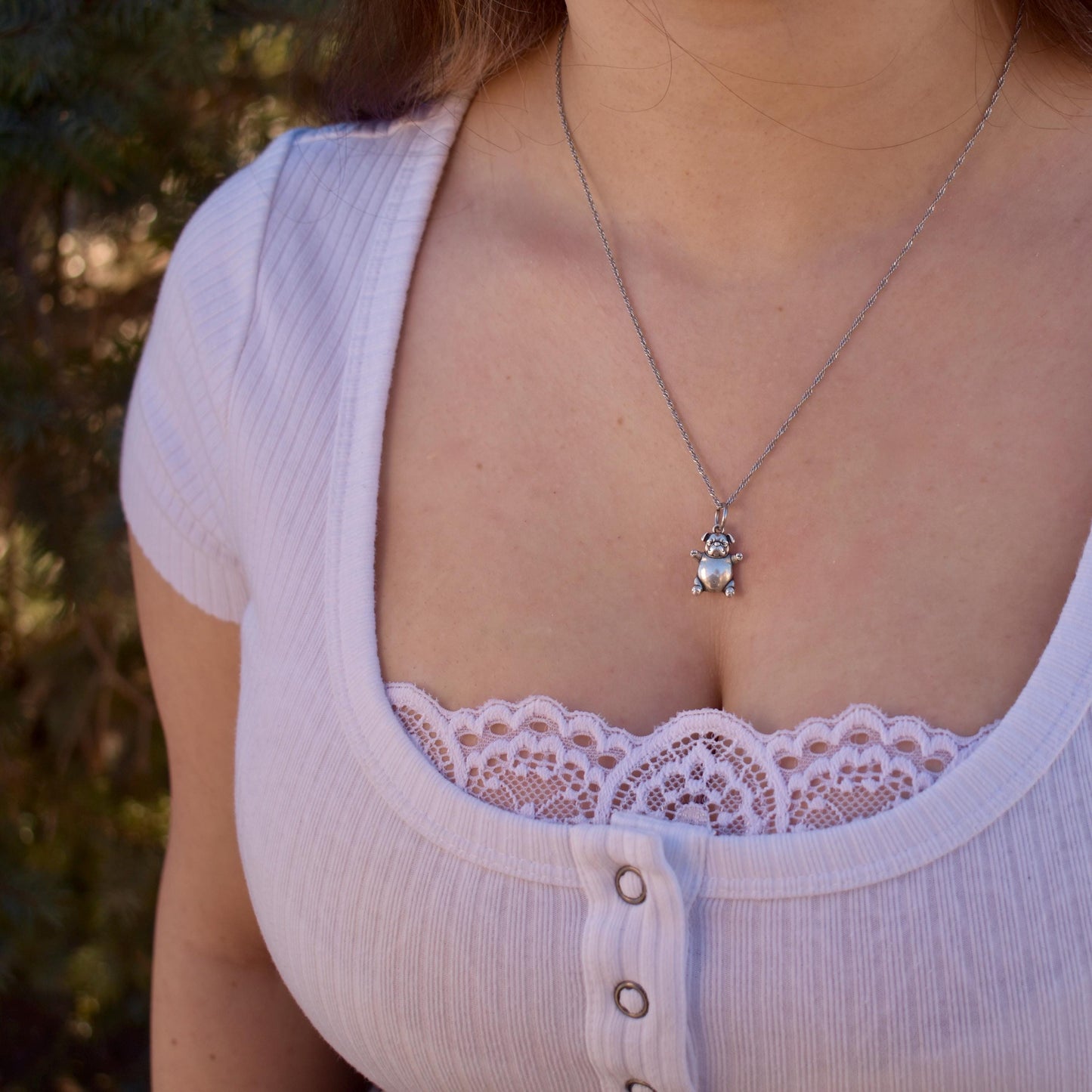 a woman wearing a pibble meme Charm on a necklace - Handcrafted .925 Sterling Silver Pendant for Bracelets and earrings by The Colorado Charm Company