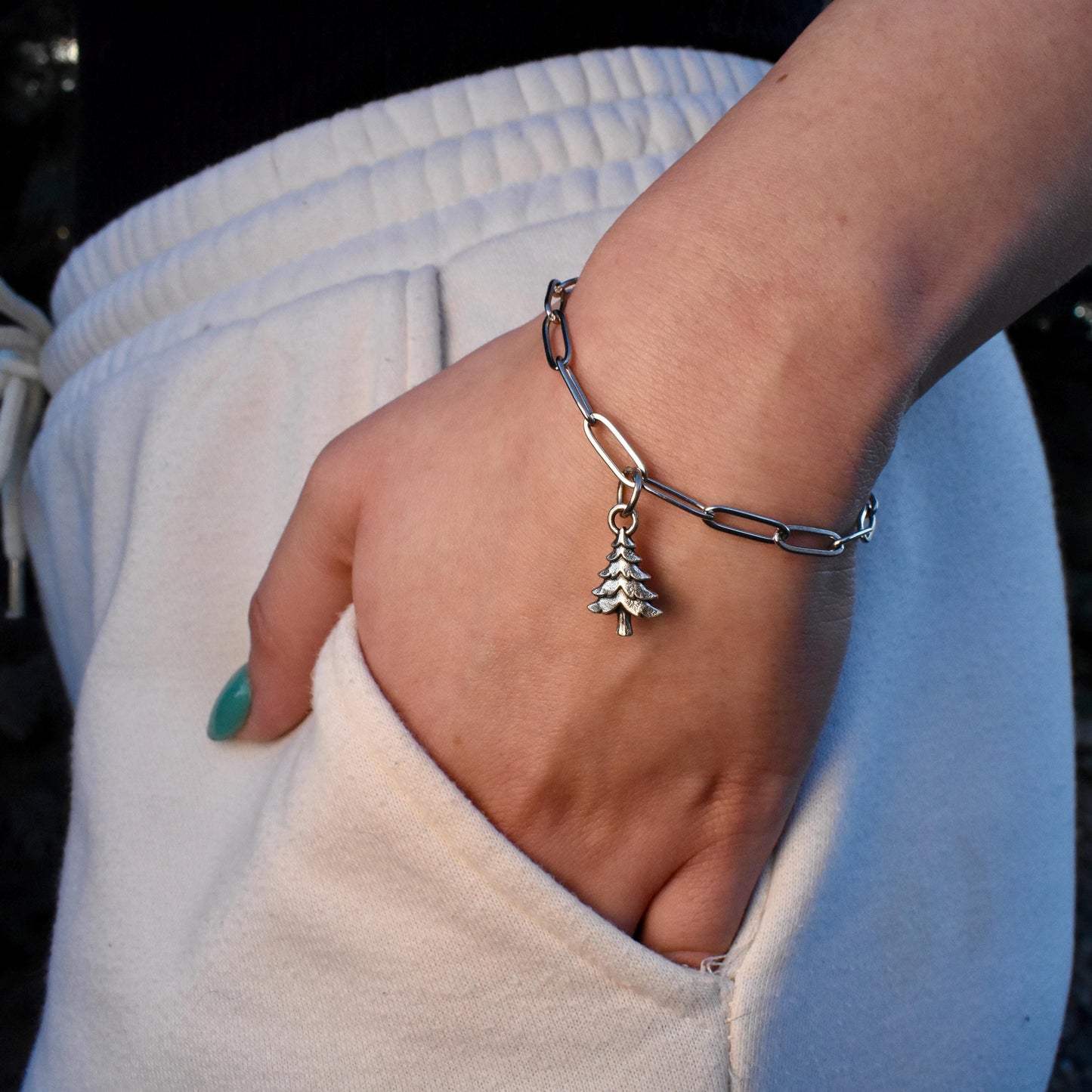 a woman wearing a pine tree charm on a bracelet - Handcrafted .925 Sterling Silver Pendant for Bracelets and earrings by The Colorado Charm Company