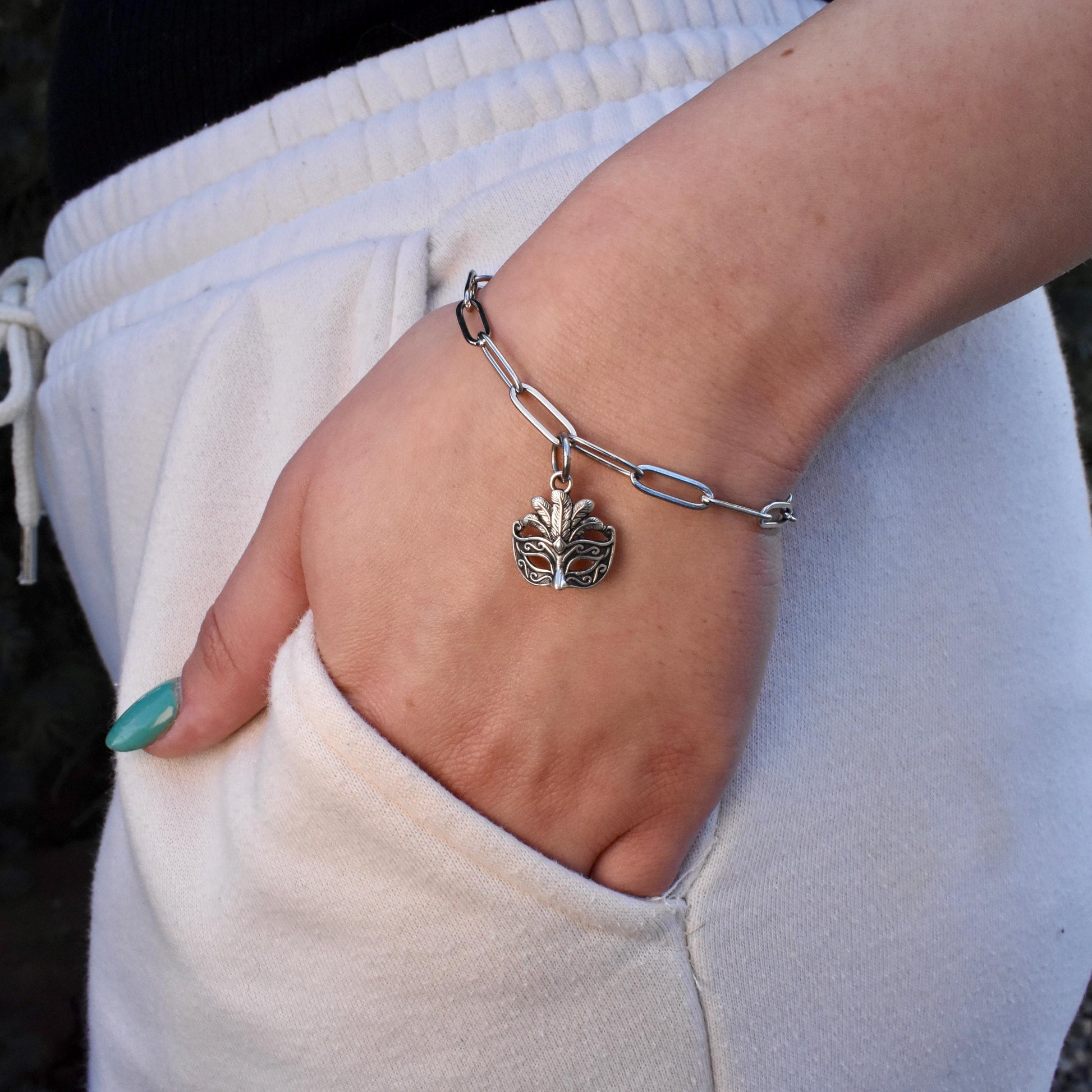 A Woman Wearing Mardi Gras Venetian Mask Charm on a bracelet - Handcrafted .925 Sterling Silver Pendant for Bracelets and earrings by The Colorado Charm Company