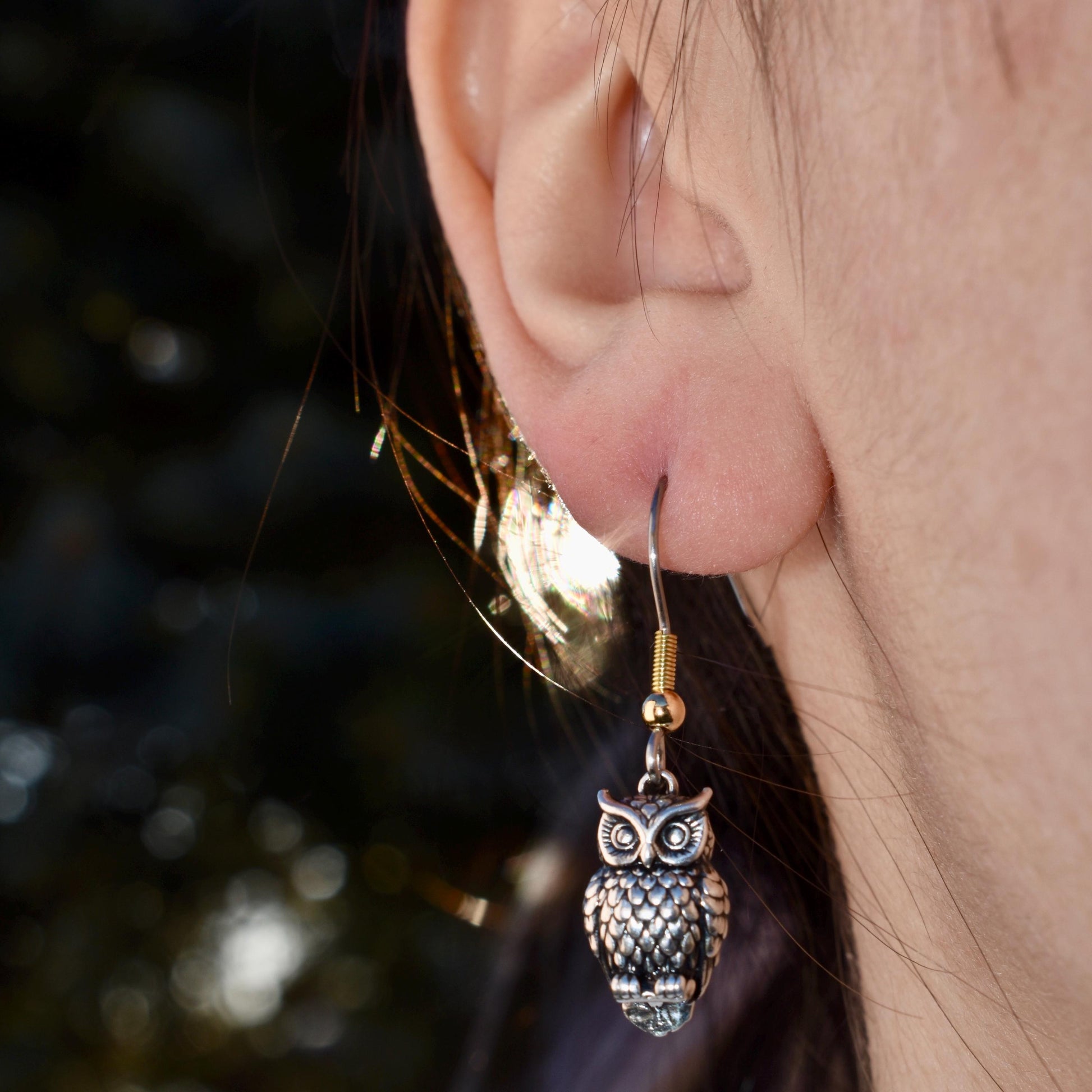 A Woman Wearing A Great Horned Owl Charm As Earrings - Handcrafted .925 Sterling Silver Pendant for Bracelets and earrings by The Colorado Charm Company 