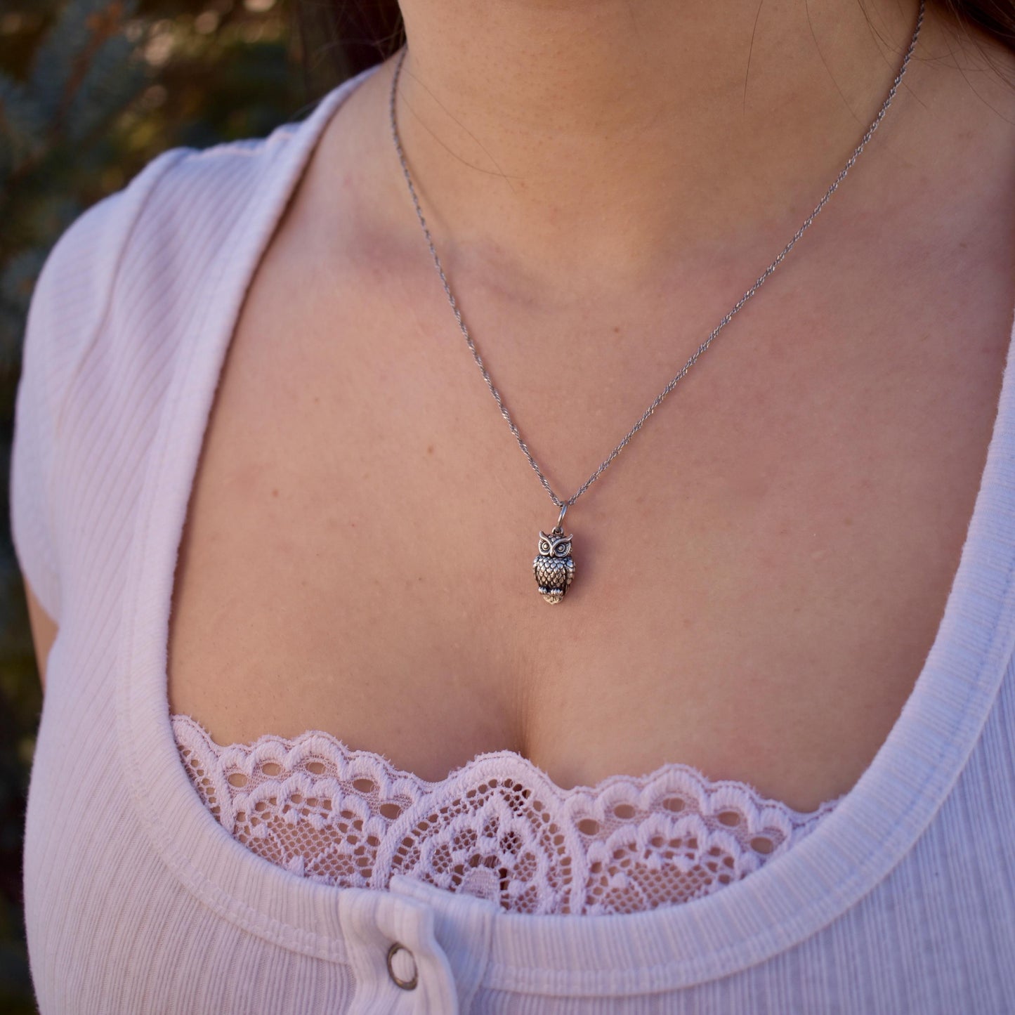 A Woman wearing a Great Horned Owl Charm on a necklace - Handcrafted .925 Sterling Silver Pendant for Bracelets and earrings by The Colorado Charm Company